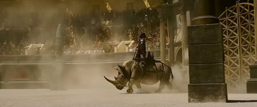 Gladiator entering Colosseum Arena on rhinoceros in Ridley Scott's Gladiator 2 showcasing ancient Roman amphitheater spectacles and gladiatorial combat featured in Carpe Diem Tours Rome Colosseum exploration and historical educational experiences