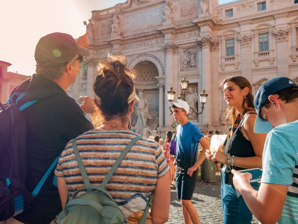 Carpe Diem tour group listening to a guide at a historical site in Rome, Italy