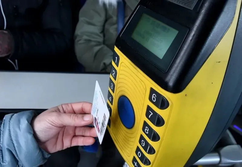 Close-up of a yellow bus ticket validation machine used for public transport in Rome, Italy