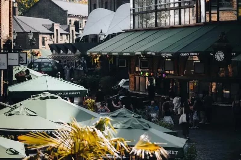Bustling Camden Market stalls with vendors and international food showcasing vibrant London market culture and diverse shopping experience during Carpe Diem Tours London cultural exploration and food tour adventure